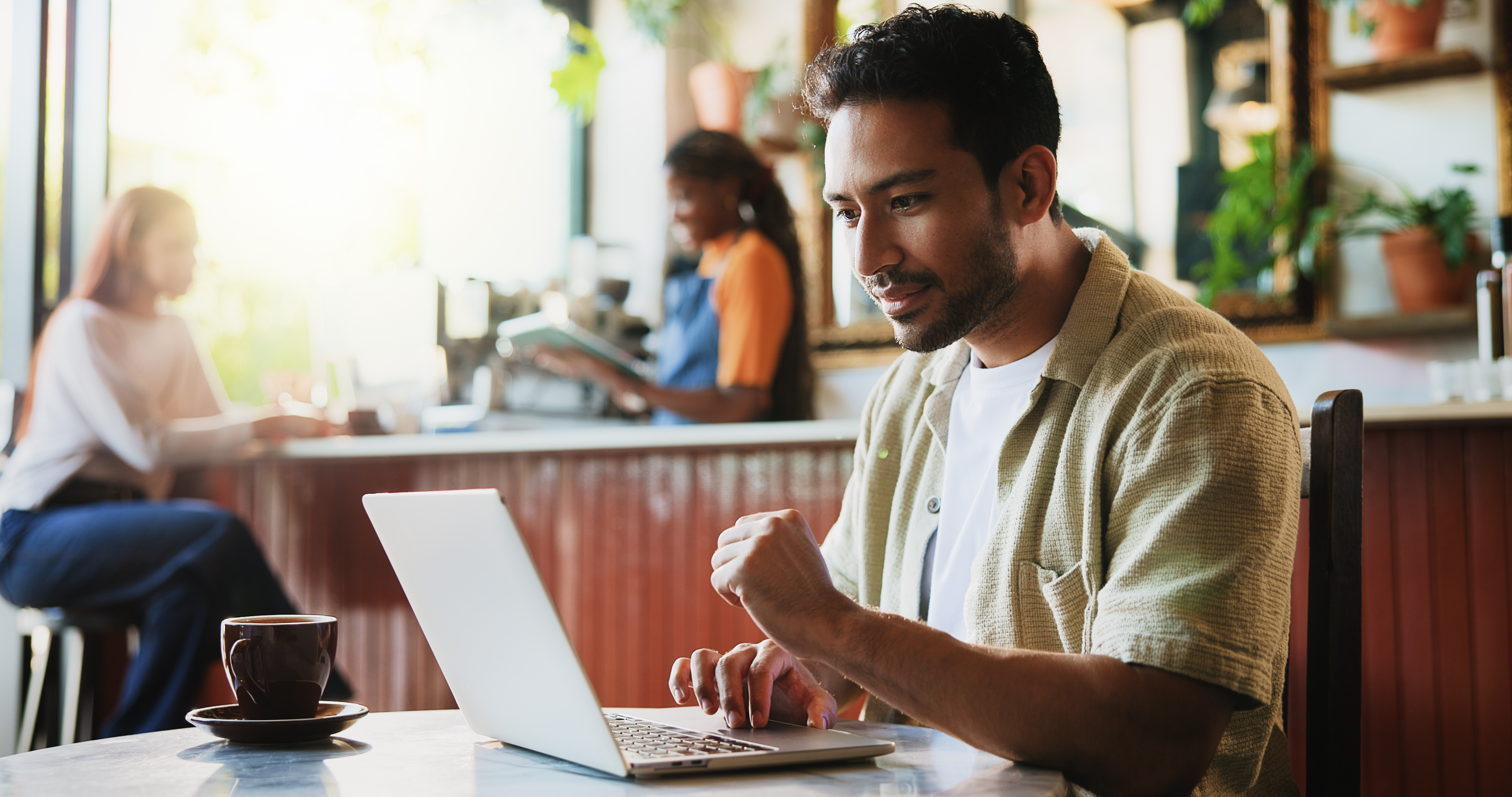Laptop, research and man in coffee shop with freelance career for cafeteria review on dining blog. Technology, warm beverage and restaurant critic with computer for online article with diner website.